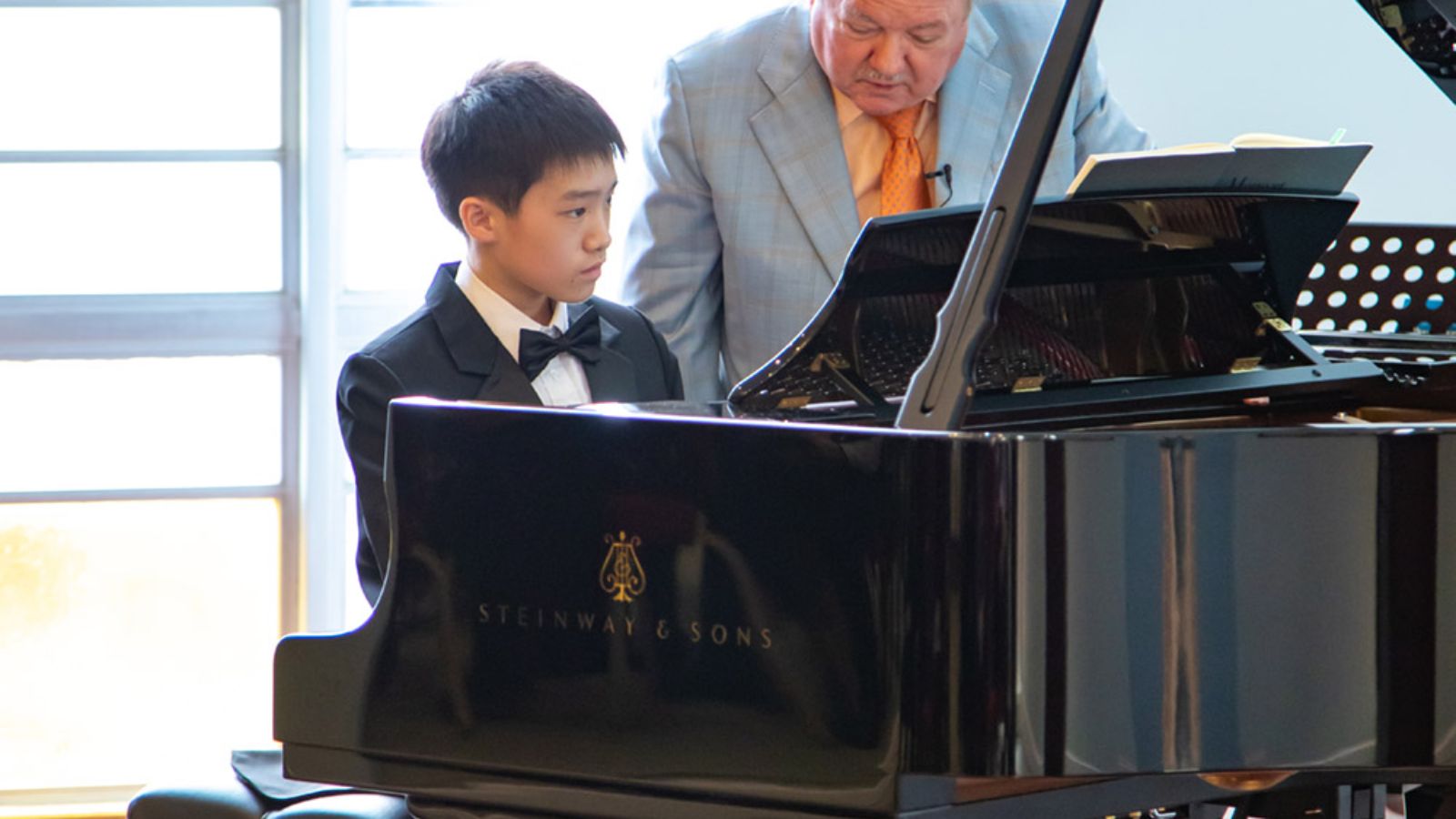 John Perry working with a student during a piano masterclass